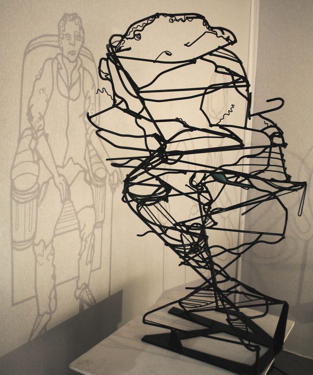 Anamorphose - man in chair wire sculpture